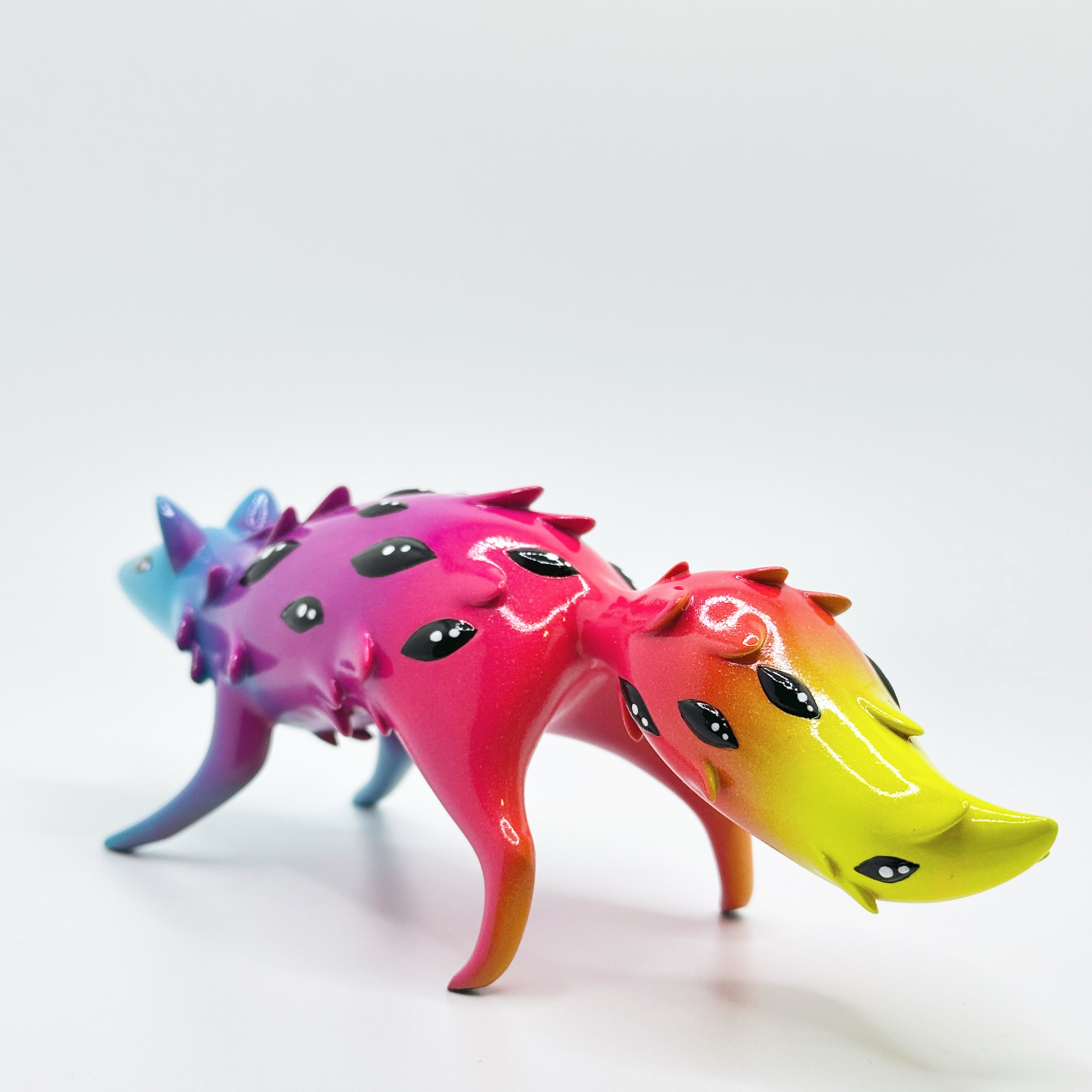 Sunset Oracle figurine by FixedTempleToys x Faunwood, featuring a horned creature with gradient colors and glossy finish, crafted in high-grade resin, 10cm tall.