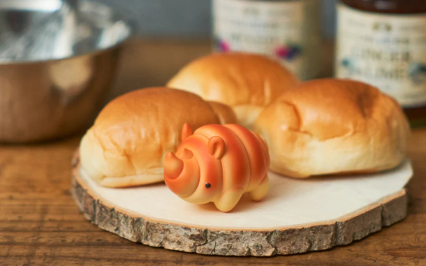 Animal Bakery Minifigure: Series 2, featuring a toy pig on a plate, resembling a freshly baked bun from the whimsical animal-themed collection.