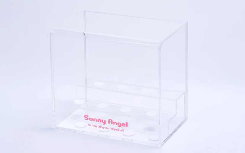 Sonny Angel Acrylic Display Case: Clear two-tier organizer with 12 recesses for figures, pink logo and phrase, includes adhesive for stability.
