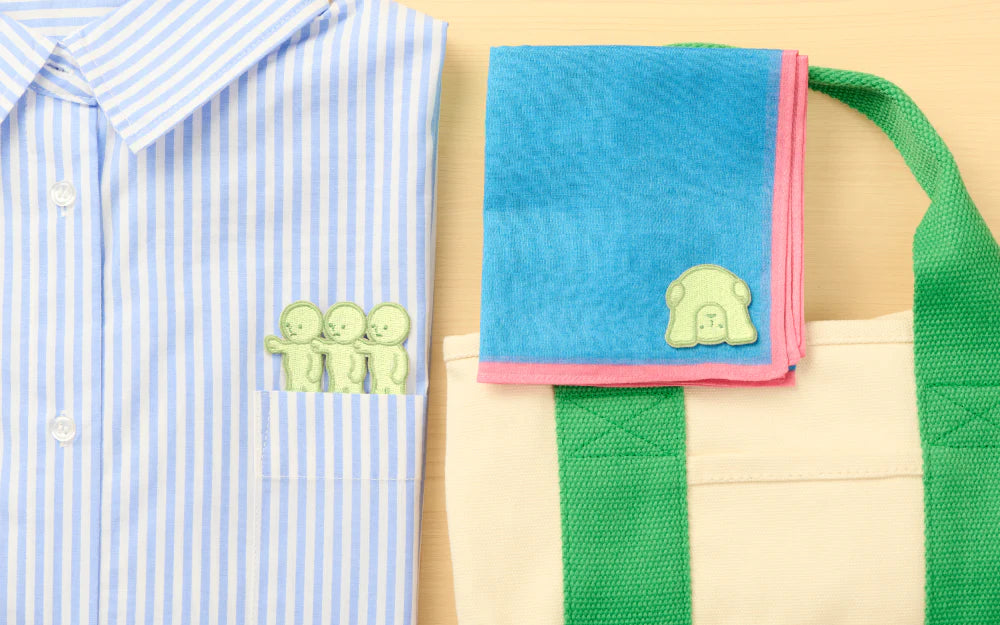 SMISKI Embroidery Sticker Vol. 2 on a striped shirt, tote bag, and hand towel, showcasing versatile decorative patches for clothing and accessories.