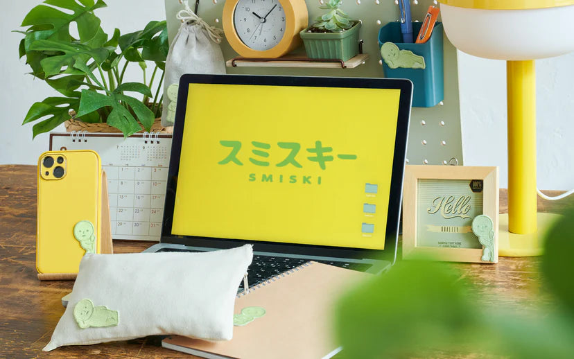 SMISKI Embroidery Sticker decorates a vibrant desk, with glow-in-the-dark figures on accessories, highlighting playful, artistic charm from Strangecat Toys.