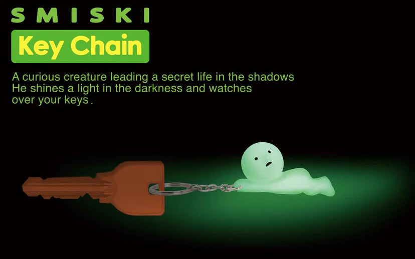 Smiski Keychain featuring a glowing toy creature with a face, designed to protect and help locate your keys in the dark.