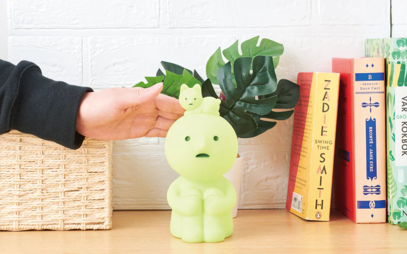 A hand holding the Smiski Touch Light, featuring Smiski daydreaming with a Smiskitty on its head. Tap to adjust brightness. Micro USB charger included. Dimensions: W83 x D92 x H173mm.
