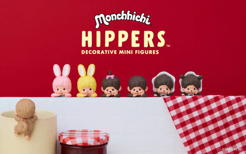 Monchhichi HIPPERS mini figures in various costumes perched on a shelf, showcasing their decorative use on everyday items.