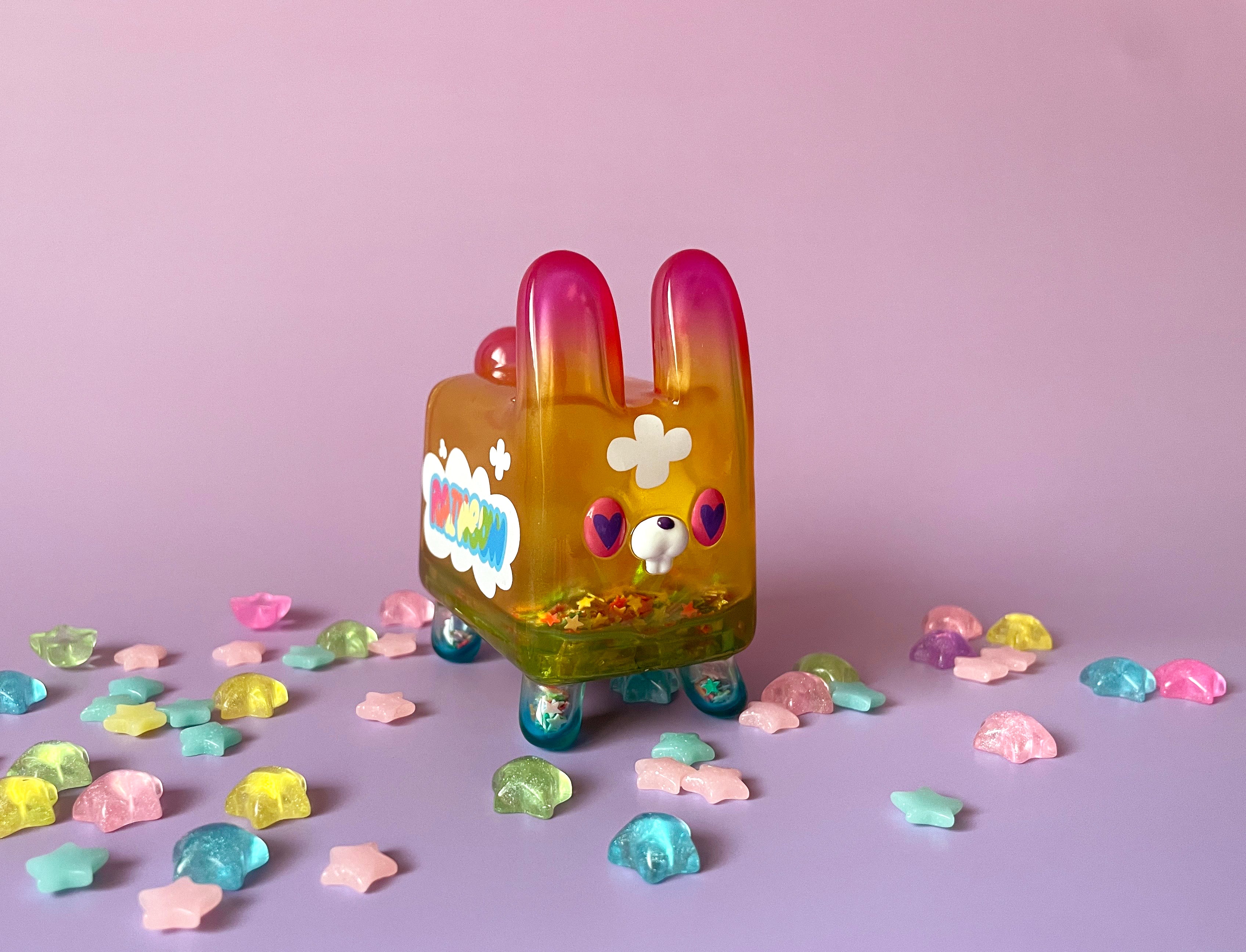 Box Rabbit - Rainbow by Rato Kim: A 2.5” x 3” soft vinyl toy featuring a plastic bunny adorned with candy, limited to 100 pieces.