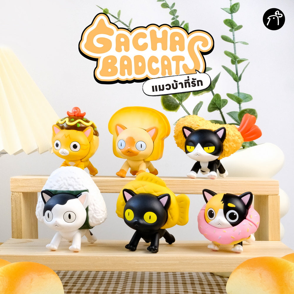 Gacha Bad Cats Blindbox features six collectible cat figurines styled as various snacks on a wooden riser, highlighting Strangecat Toys' quirky art toy selection.