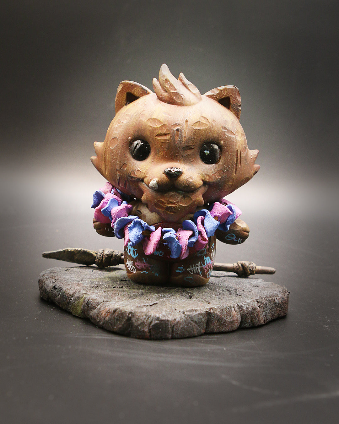 A 4-inch vinyl cat statue, Grandpa Character from Grandpa & Friends 2 - Tiki Tooth, designed by InPrimeWeTrust, featuring a necklace and spear.