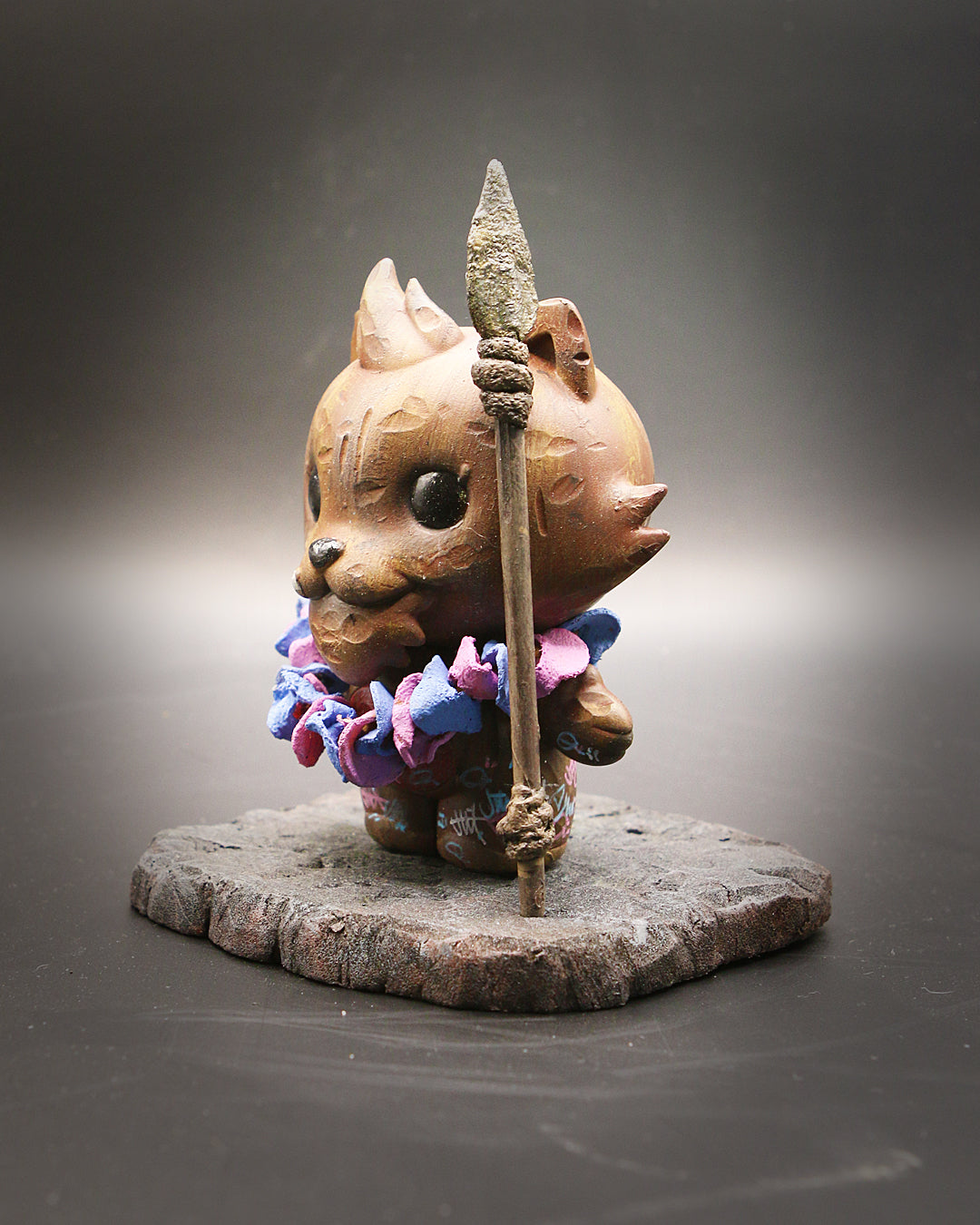 Statue of a cat holding a spear, part of the Grandpa & Friends 2 - Tiki Tooth series by Richard Page, 4 vinyl collectible.