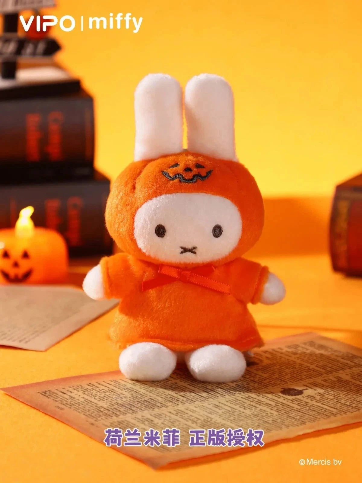 Miffy Halloween Plush Keychain Blindbox in pumpkin costume, posed with books and jack-o’-lantern, officially licensed, available for preorder at Strangecat Toys.