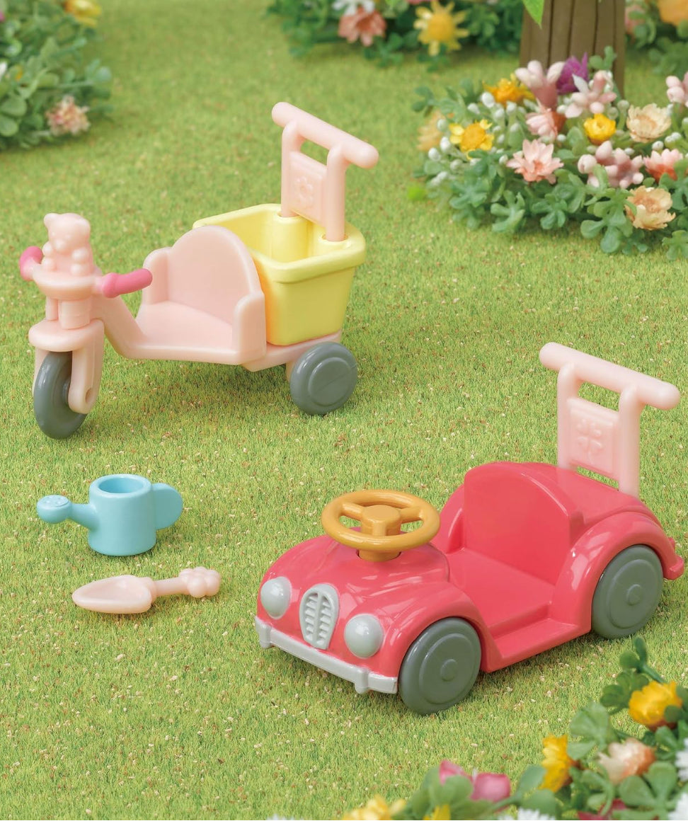 Sylvanian Families Tricycle and Car Furniture series featuring a toy tricycle, car, and watering can on grass, for enhancing Calico Critters playtime.