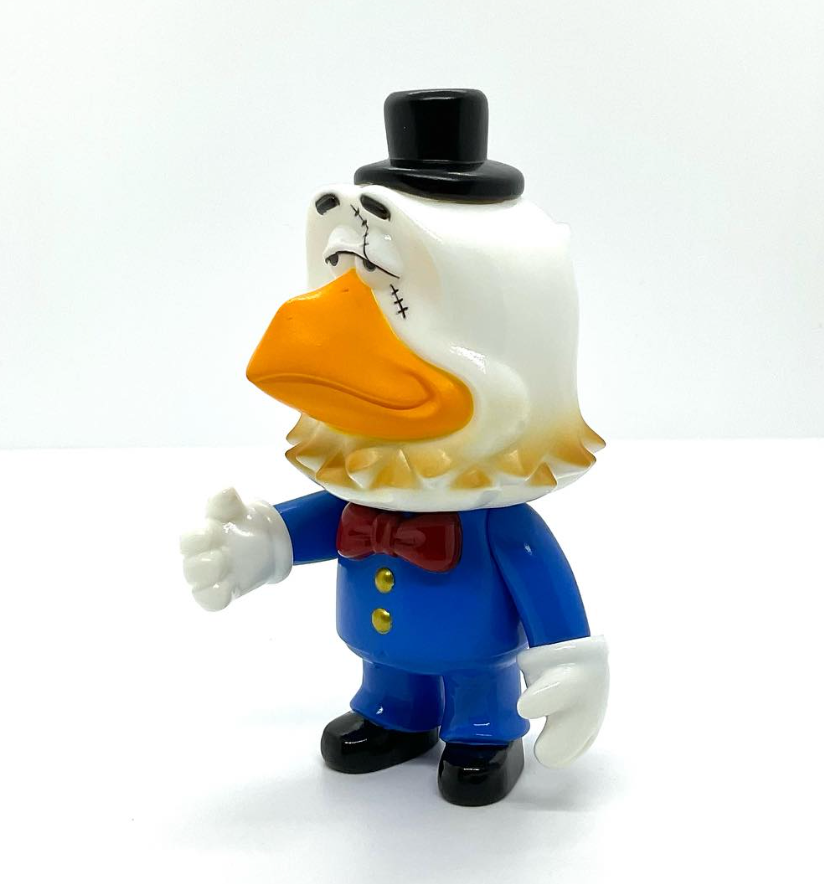 SwingBird Mini by Swingtoys: A 13cm designer toy of an eagle in a blue suit with quirky stitched-scar details, photographed on a white background.
