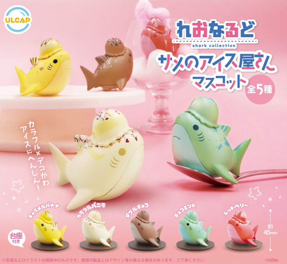 A group of small plastic toys, including a green object on a red plate, a toy fish with a hat, and a statue, from the Shark Ice Cream Shop Gacha.