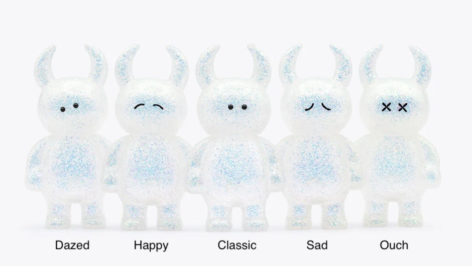 UAMOU WHITE OPAL: Five 7cm soft vinyl figurines with unique expressions—Dazed, Happy, Classic, Sad, Ouch—featuring horns and glitter, crafted in Japan.
