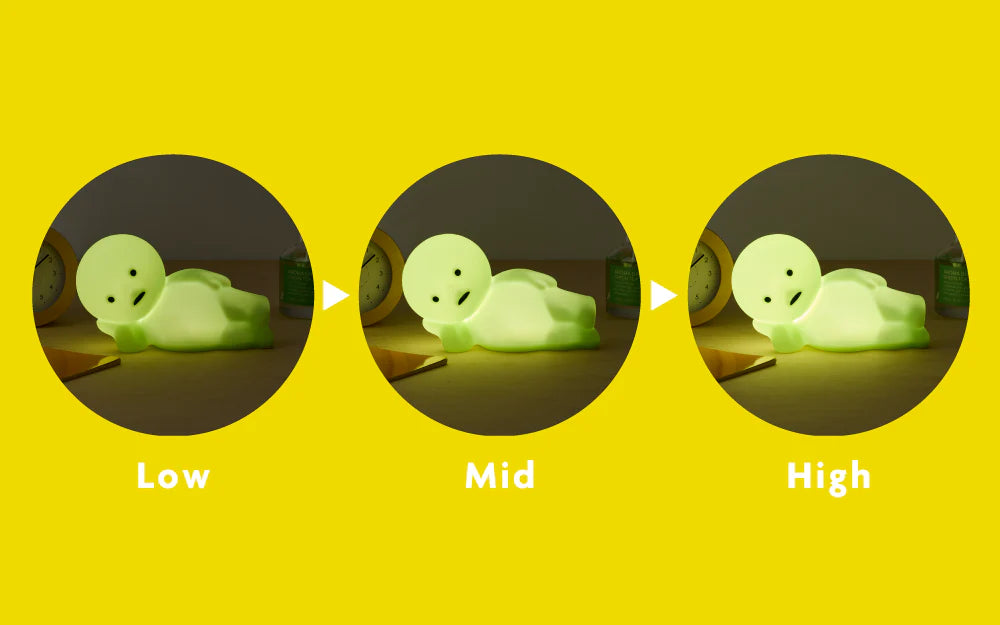 SMISKI Touch Light Vol. 2 glowing on a desk, showing three brightness settings with an alarm clock and pencil in the background.