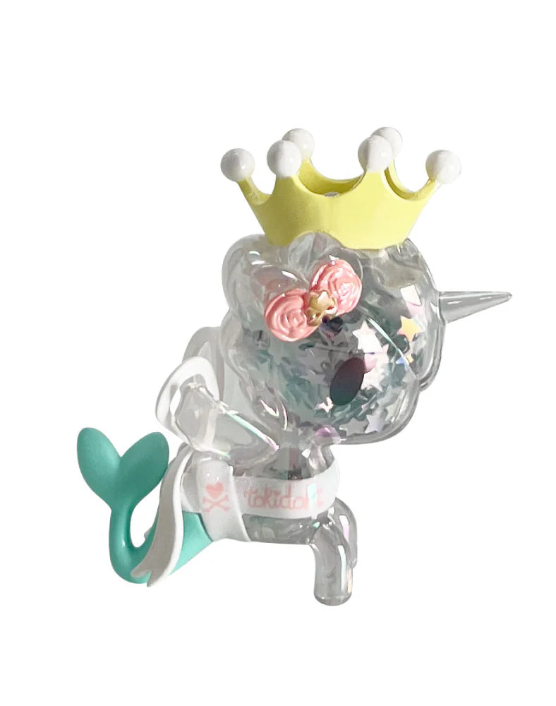 tokidoki 20th Anniversary Blind Box: A 2.7-inch translucent unicorn/mermaid figurine with star confetti, mint-green tail, yellow crown, pink floral headband, and tokidoki branding.