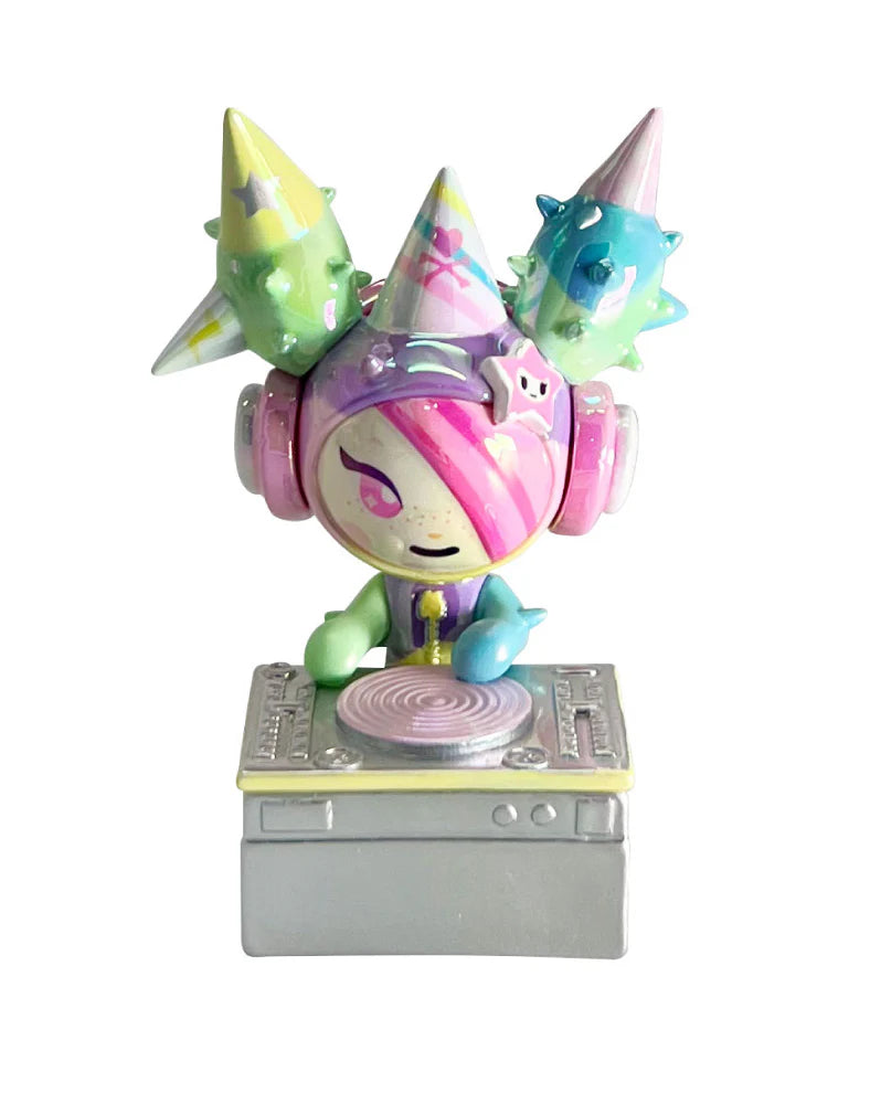 tokidoki 20th Anniversary Blind Box figure with pastel hair, headphones, and horns, posed behind a DJ turntable in playful celebration design.