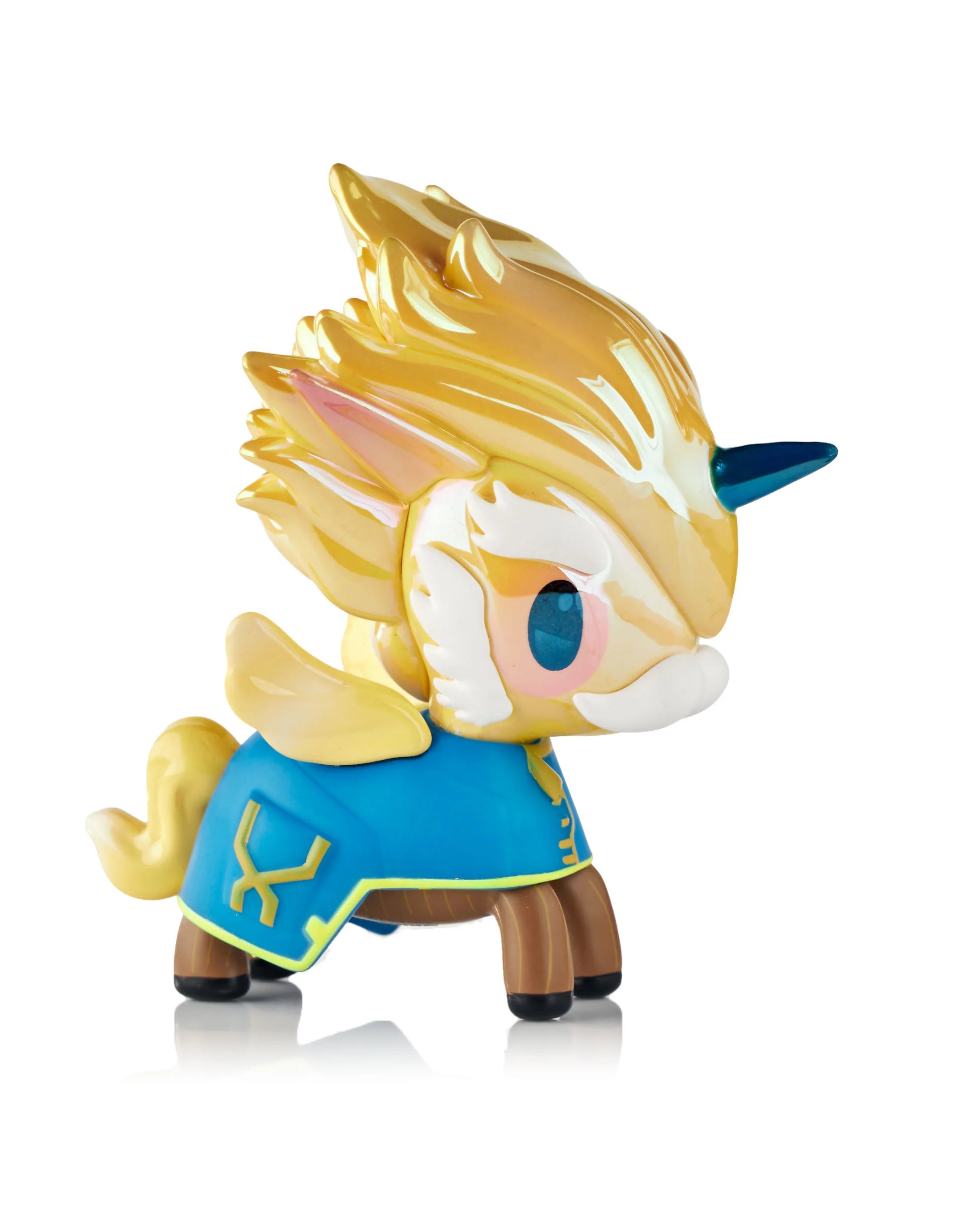 Tokidoki x ARCANE Unicorno Black Light Chrome Blind Box vinyl toy with golden mane, blue horn, and cloak; collectible art figure glowing under black light.
