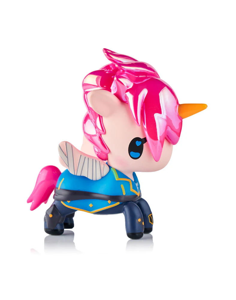 Tokidoki x ARCANE Unicorno Black Light Chrome Blind Box: Chibi unicorn figurine with pink mane, orange horn, big eyes, wings, blue-gold jacket, and dark pants.