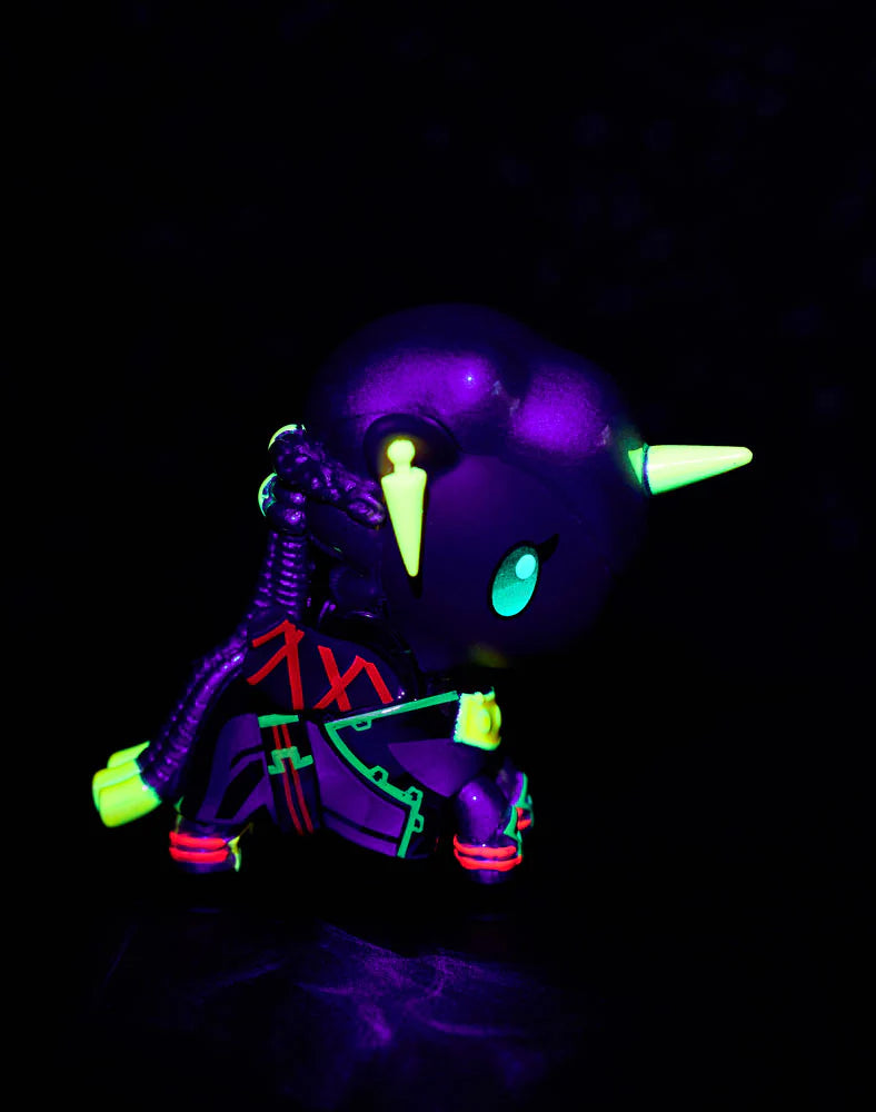 tokidoki x ARCANE Unicorno Black Light Chrome Blind Box figurine, glowing matte purple with neon-green accents under blacklight, collectible vinyl art toy, 2.75 inches tall.