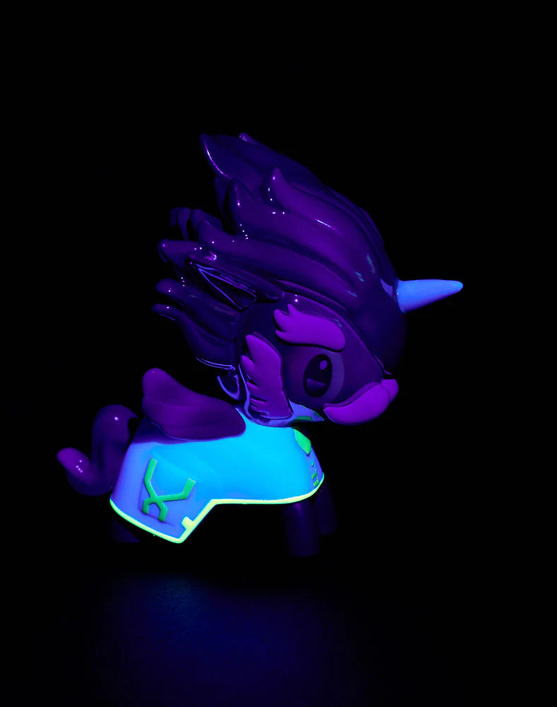 tokidoki x ARCANE Unicorno Black Light Chrome Blind Box figure, glowing under blacklight with vivid colors, featuring a stylized unicorn with a horn, mane, tail, and cape.
