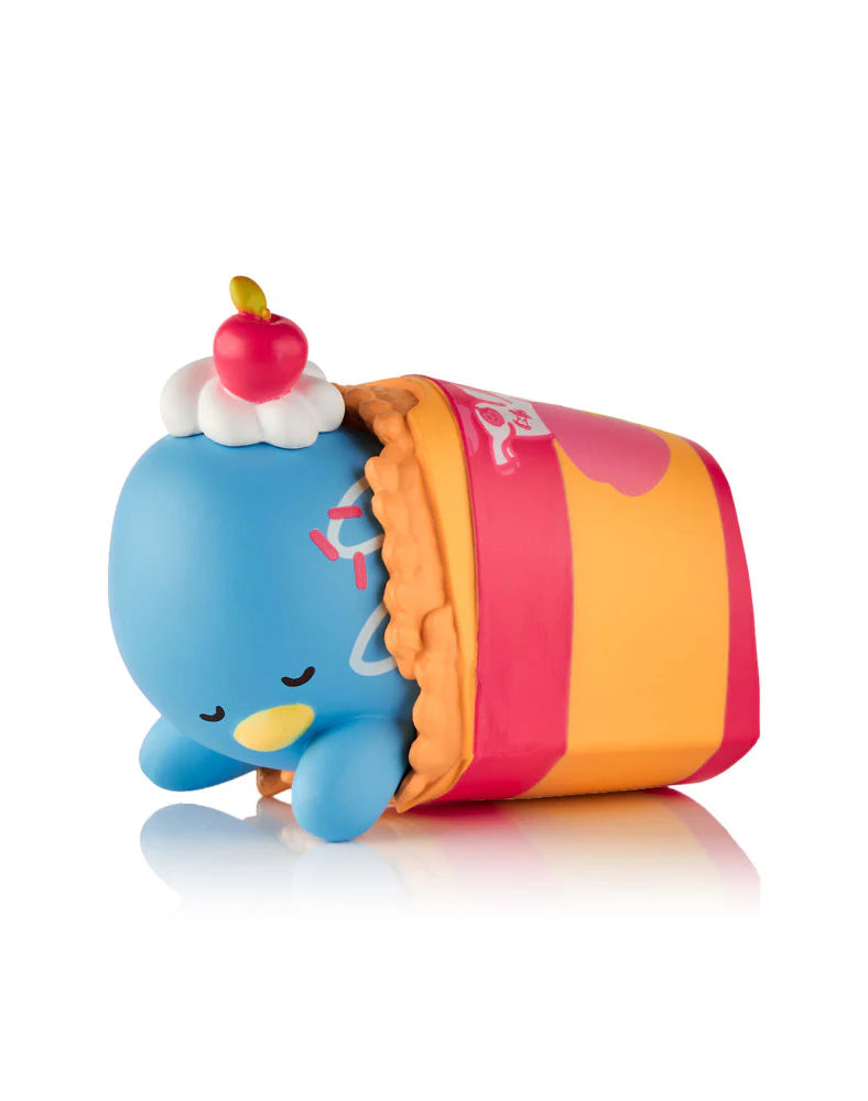 tokidoki x Hello Kitty and Friends Fast Food Blind Box: A blue vinyl figure with whipped cream and cherry, lounging in a pink-orange waffle-textured carton.