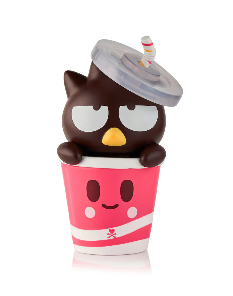 Kawaii-style figurine of a grumpy owl-cat hybrid in a pink cup from tokidoki x Hello Kitty and Friends Fast Food Blind Box series.