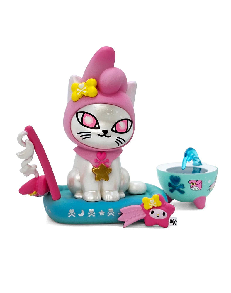 Tokidoki Galactic Cats x Hello Kitty & Friends Blind Box featuring a kawaii cartoon cat with pink hood, blue moon-print float, and teal cauldron accessory.