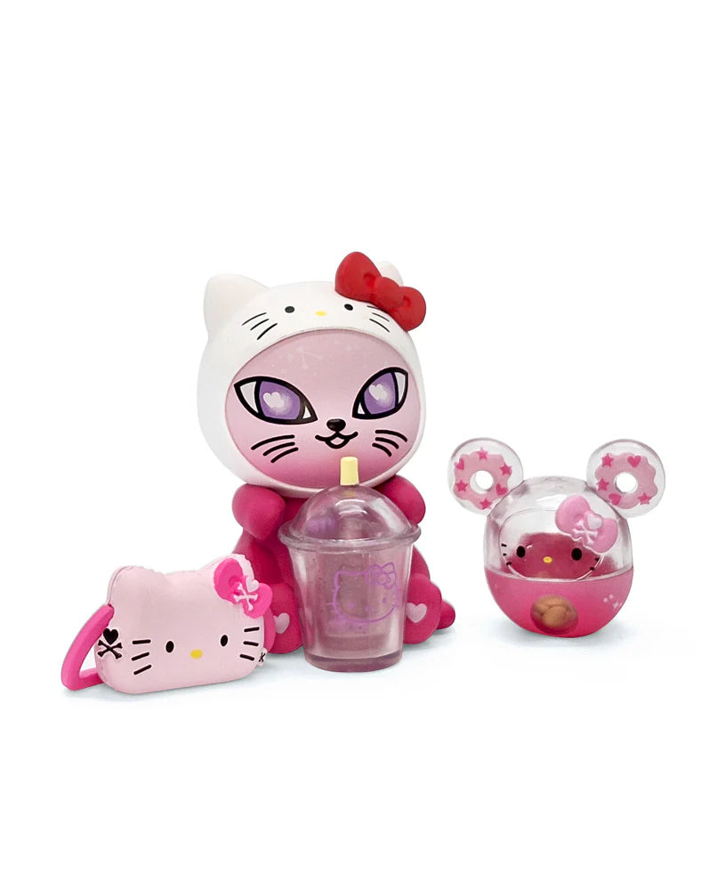 tokidoki Galactic Cats x Hello Kitty & Friends Blind Box: Cat figure in white hood with bow, pink drink cup, kitty-face charm, mouse-ear capsule.