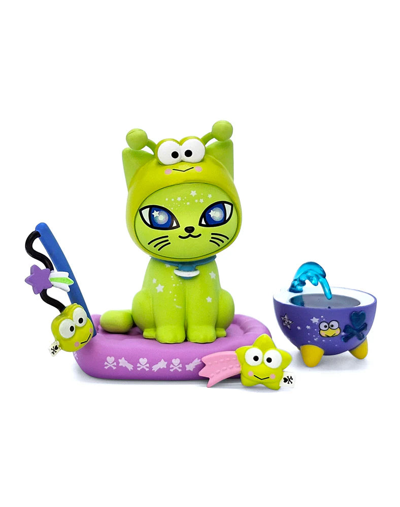 tokidoki Galactic Cats x Hello Kitty & Friends Blind Box featuring a frog-hooded cat on a purple platform with whimsical accessories, including a wand and basin.