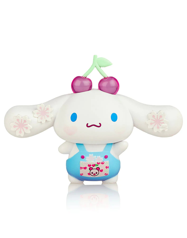 A blind box toy featuring tokidoki x Hello Kitty characters with cherries and other cute designs.