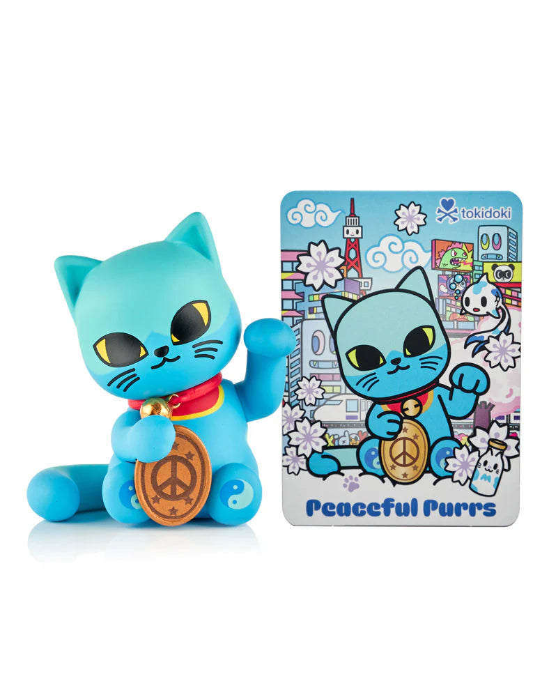 Tokidoki “Peaceful Purrs” vinyl figure from Lucky Cats Blind Box, featuring a teal maneki-neko with peace medallion and yin/yang accents, includes matching art card.
