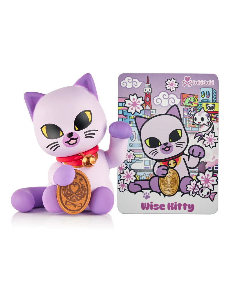 Tokidoki Lucky Cats Blind Box features a lavender Maneki-Neko figure with red collar and gold coin, paired with a Wise Kitty collector card.