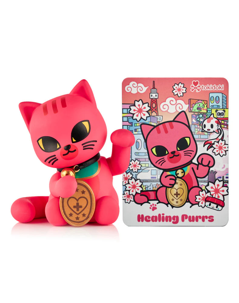 Tokidoki Healing Purrs vinyl figure, part of Lucky Cats Blind Box series, features a pink maneki-neko and includes a matching collector card.