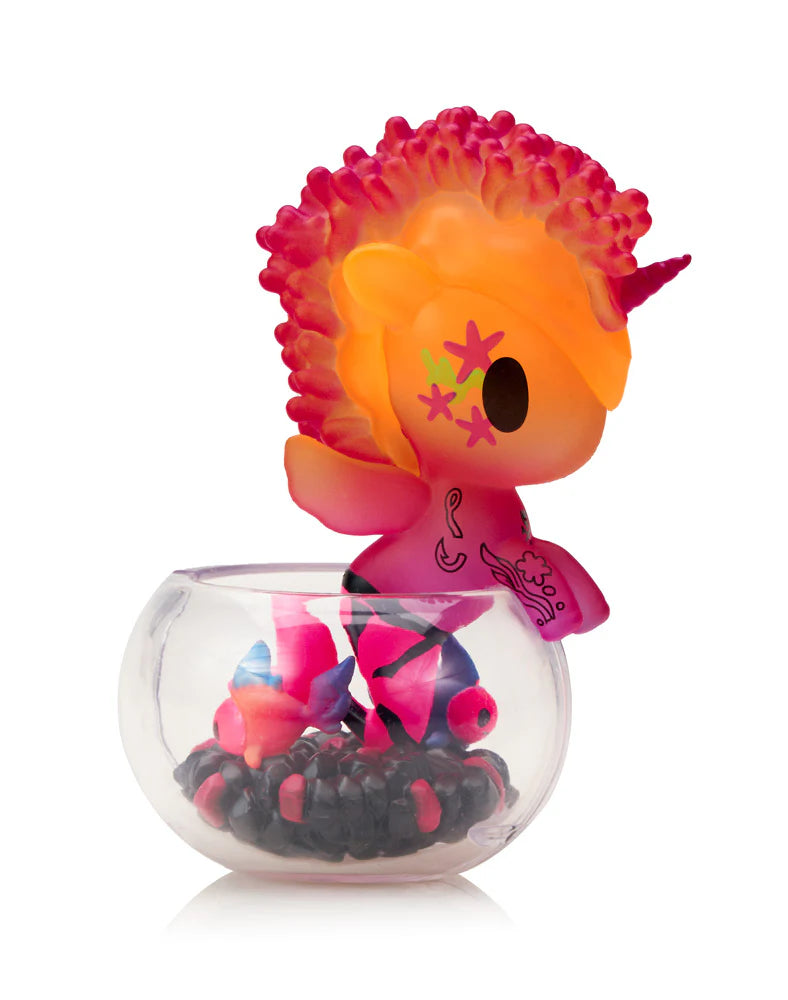 Neon Reef Mermicorno Blind Box features a neon-pink/orange unicorn-mermaid figurine with matching fish, perched on a clear bowl with black and pink beads.