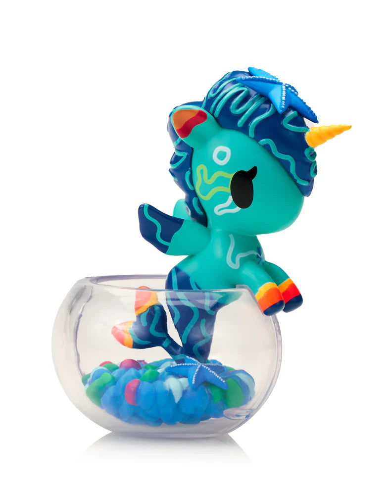 Neon Reef Mermicorno Blind Box: Teal unicorn with mermaid tail, starfish mane, orange horn, on fishbowl rim, glowing under blacklight. Collectible art toy.