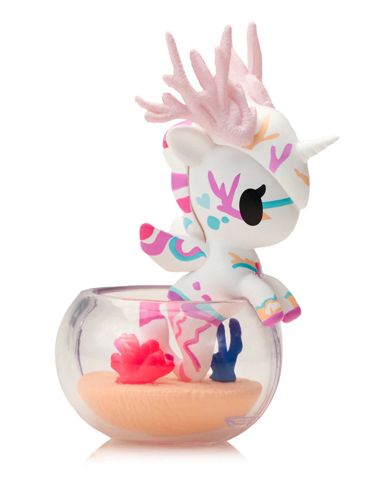 Neon Reef Mermicorno Blind Box: A collectible vinyl unicorn-seahorse hybrid with pastel coral antlers, tribal markings, perched on a fishbowl, glowing under blacklight.