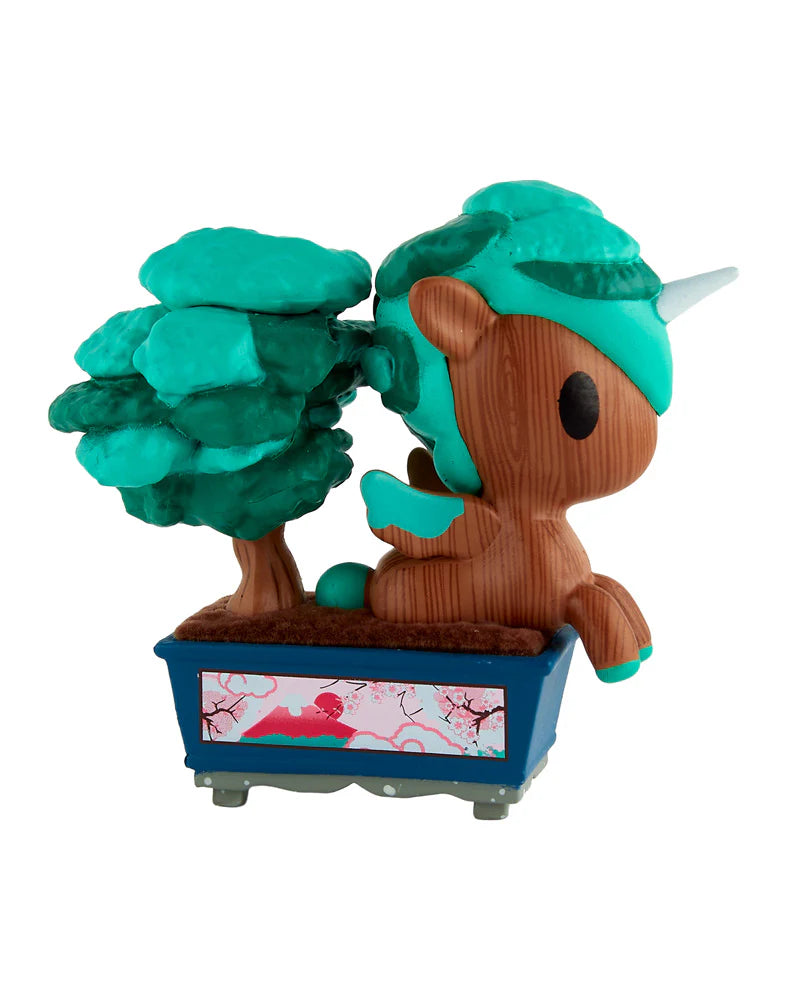 Botanical Bonsai Unicorno Blind Box figurine, featuring a wood-textured unicorn with teal mane, in a blue planter, alongside a bonsai-style tree.