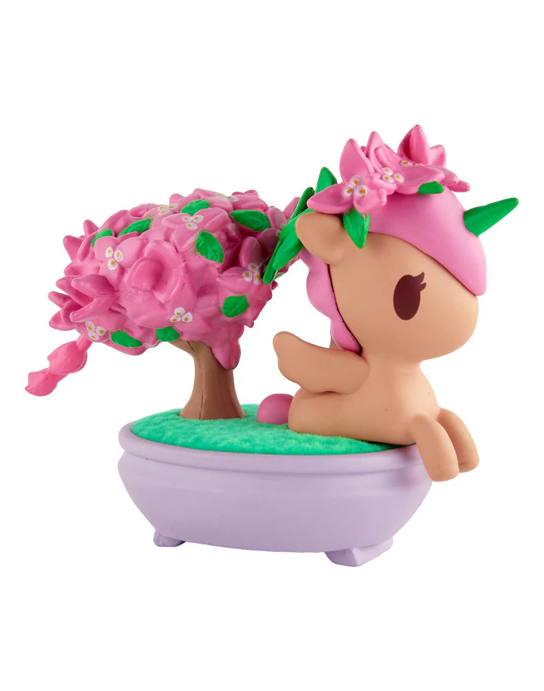 Botanical Bonsai Unicorno - Pink Bougainvillea Bonsai (Special Edition) reclining with cherry-blossom decor beside a bonsai tree in a lavender pot, collectible art piece.