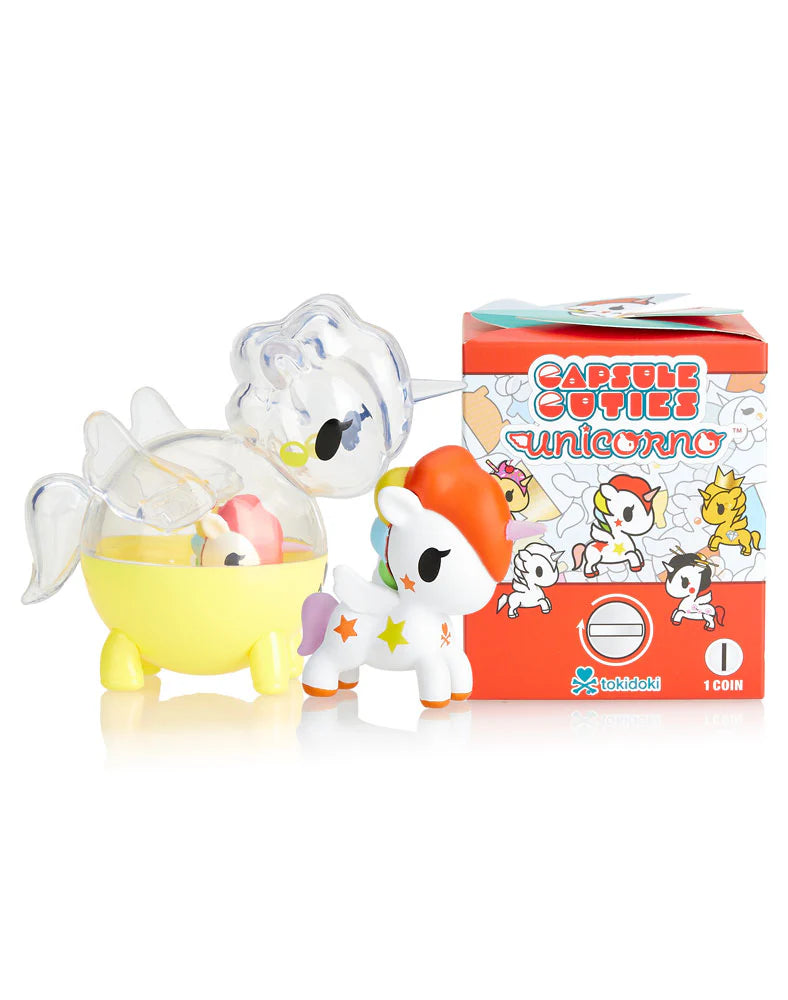 Capsule Cuties Unicorno Blind Box with toy unicorns and box featuring cartoon unicorns, showcasing surprise mini figures in a blind box format.