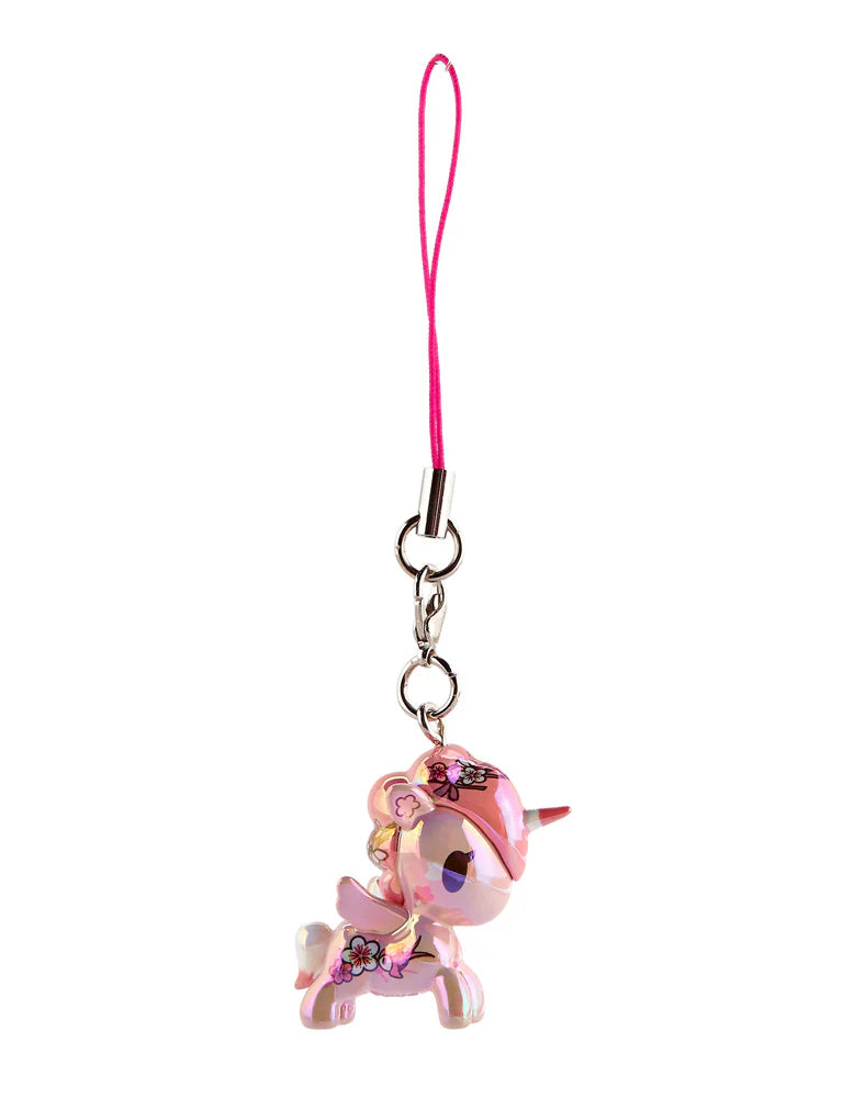 Shimmer Cherry Blossom Unicorno Frenzies Blind Box shows a translucent pink unicorn charm with floral decals, attached to a pink strap and metal clasp.