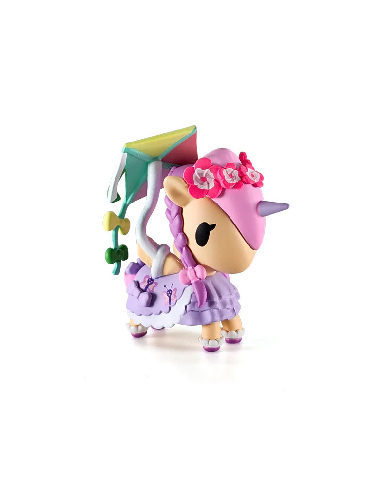 Picnic Party Unicorno Blind Box featuring a kawaii unicorn figurine with pink mane, lavender horn, butterfly dress, and kite, embodying Strangecat Toys’ playful, collectible charm.