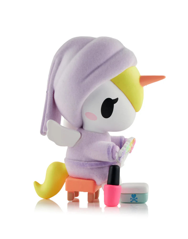 Spa Day Unicorno Blind Box - Preorder: Unicorn figurine in lavender robe, painting hooves with pink nail polish, includes mystery accessories for collectors.