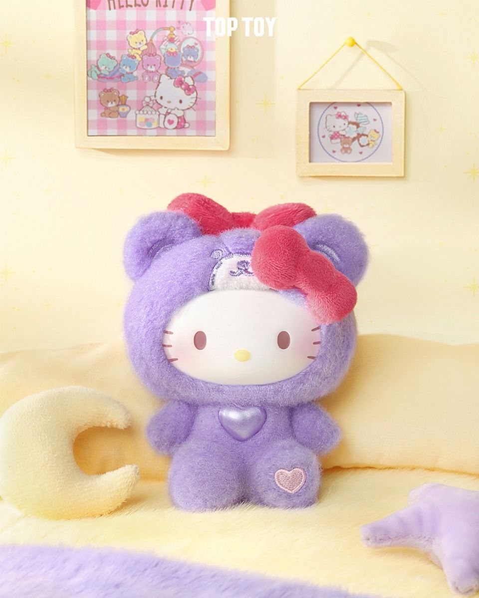 Sanrio Teddy Pajamas Plush Keychain Blind Box features Hello Kitty in a purple bear costume with a red bow, seated on a soft surface.