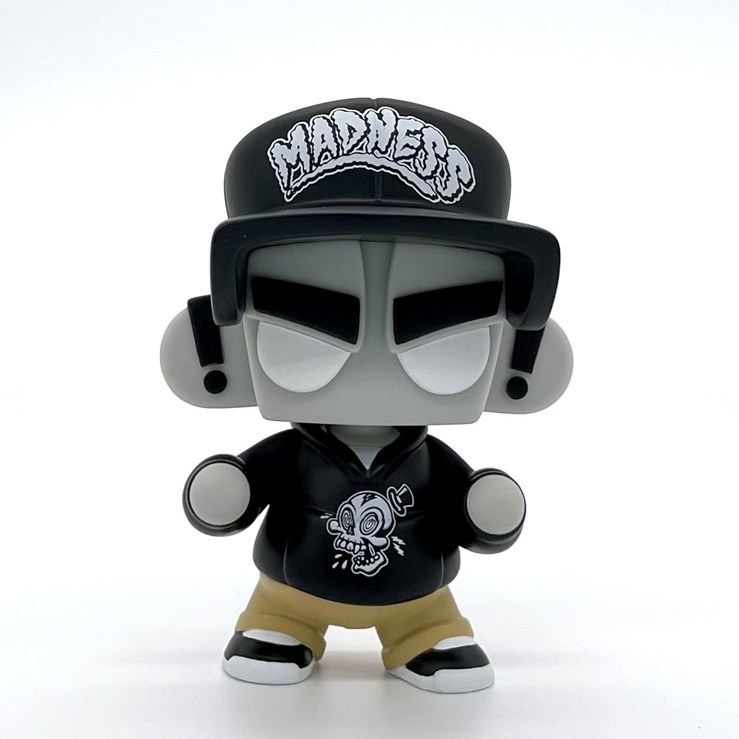Toy figurine of MAD*L Citizen Black Hat Edition by Jeremy Mad'L with a skull design, hoodie, and khakis, featuring a ball-jointed neck for dynamic poses.