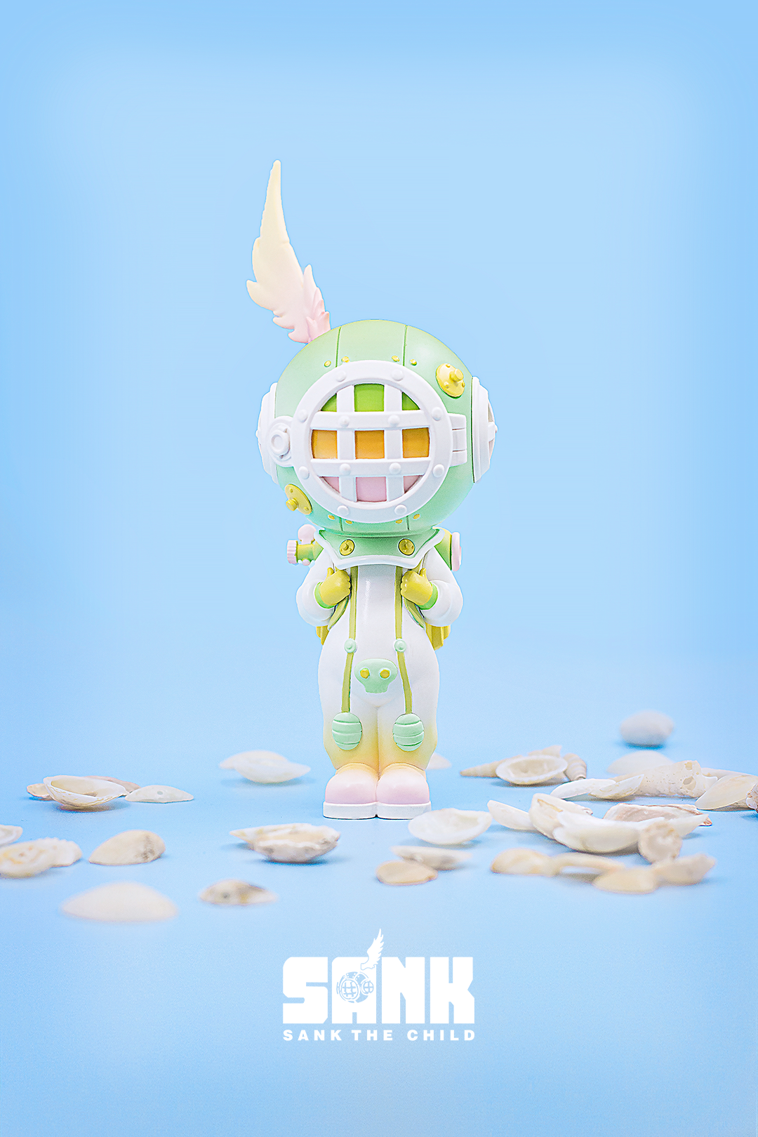 Toy figure with shells, cartoon character statue, blue and white sign, white feather, blue and white logo, toy on the floor, green object, white object on blue surface - On the Way Series The Diver-Green by Sank Toys.