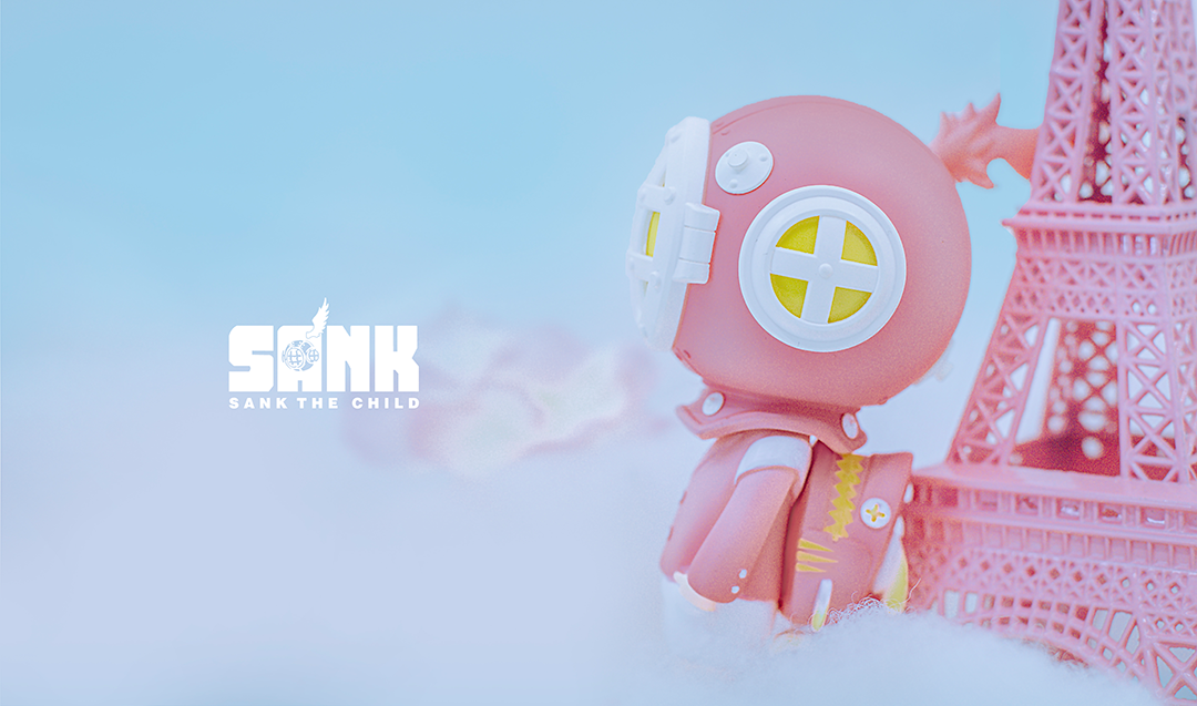 A close-up of a toy with yellow eyes, part of On The Way - Backpack Boy - Encounter by Sank Toys collection.