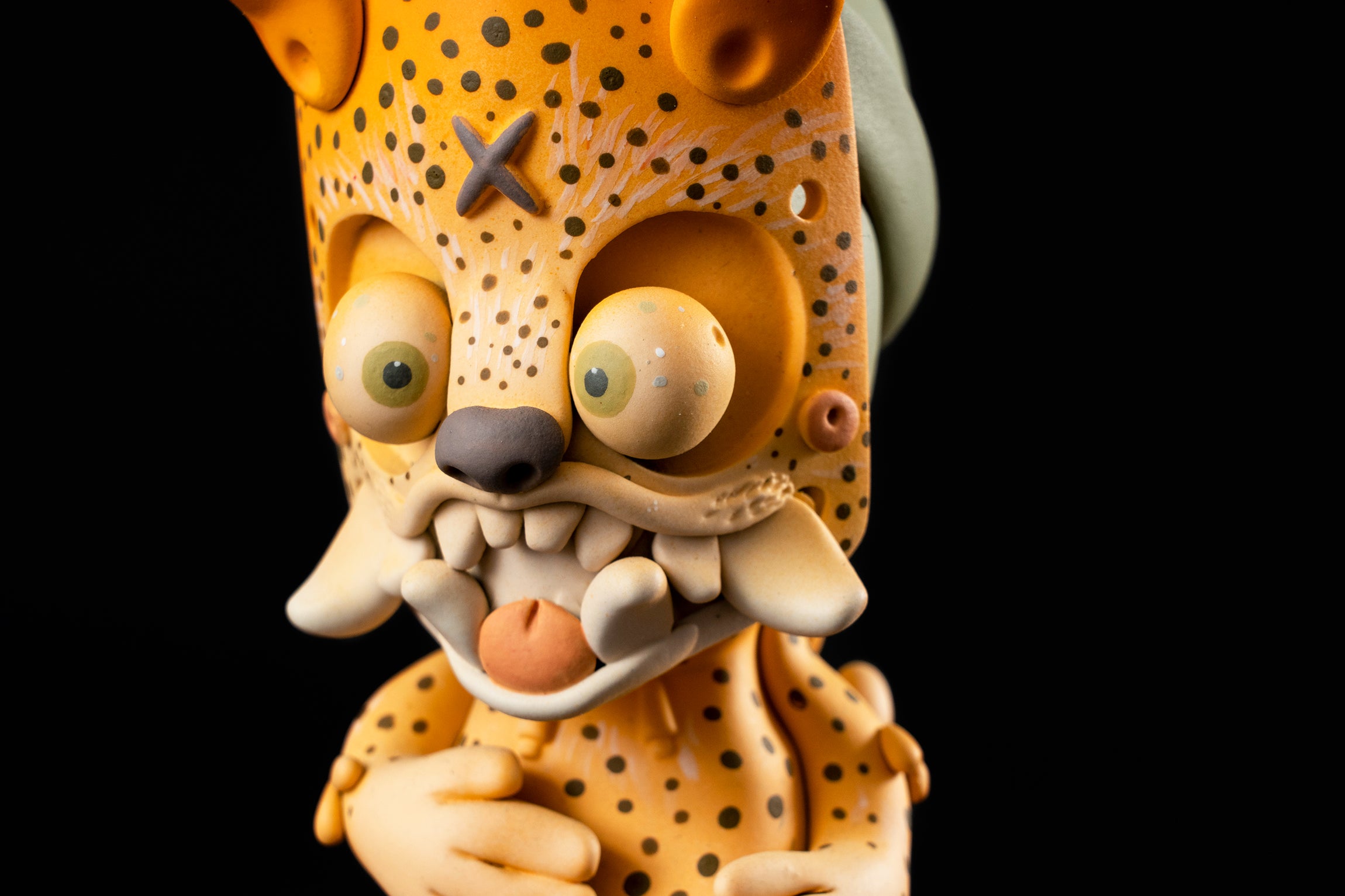 Toy figurine of a cartoon character, close-up details of a sculpture, egg, and letter X.