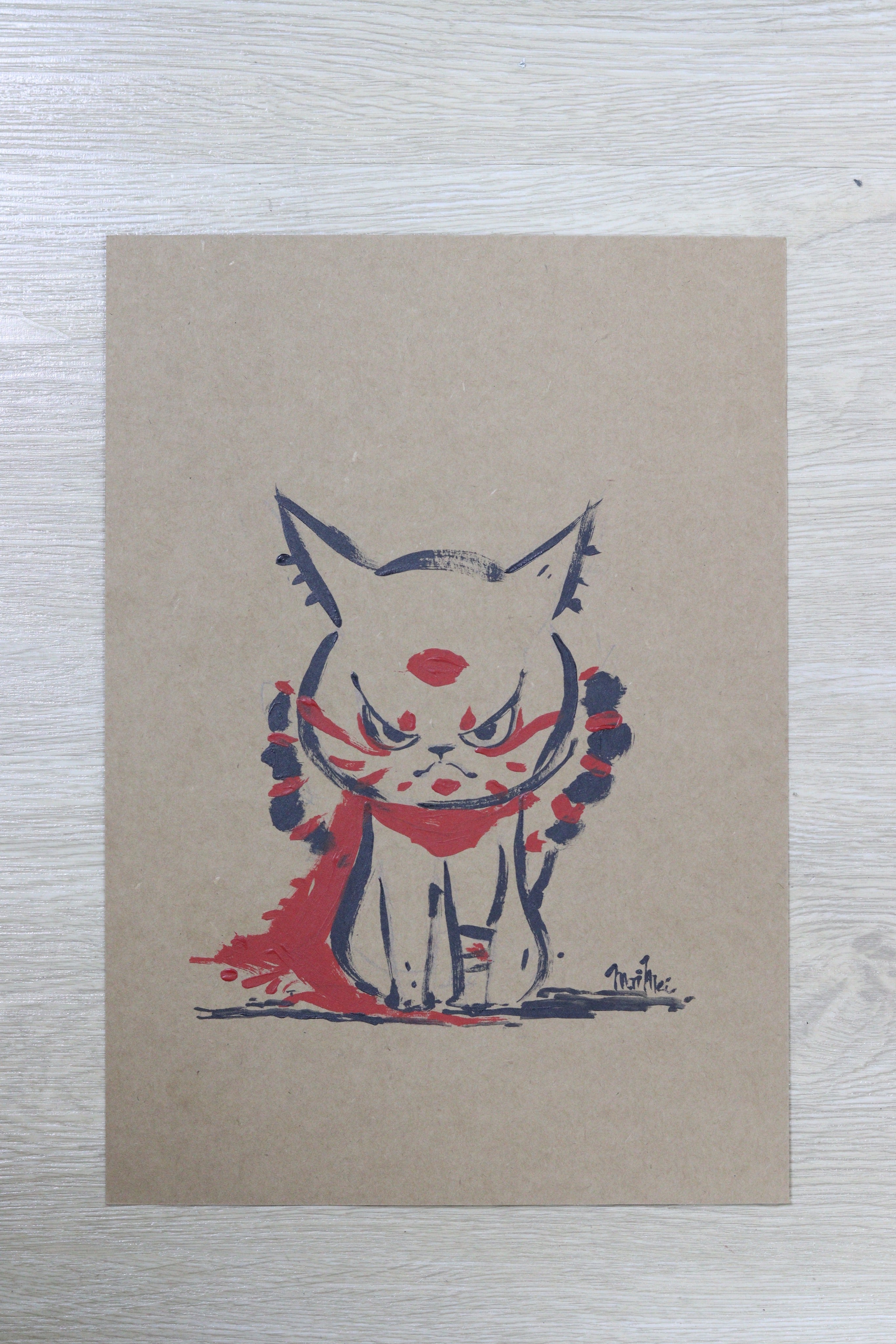 Child-like sketch of a cat drawing on cardboard, framed.