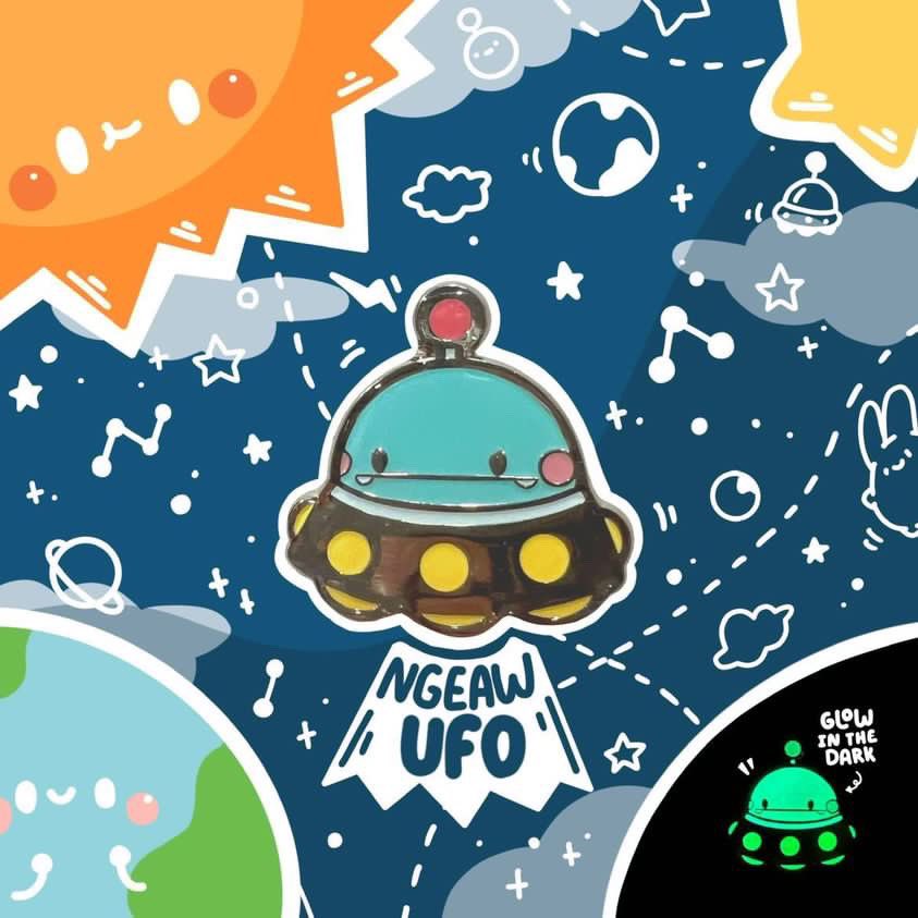 A cartoon enamel pin with a face and yellow circle border.