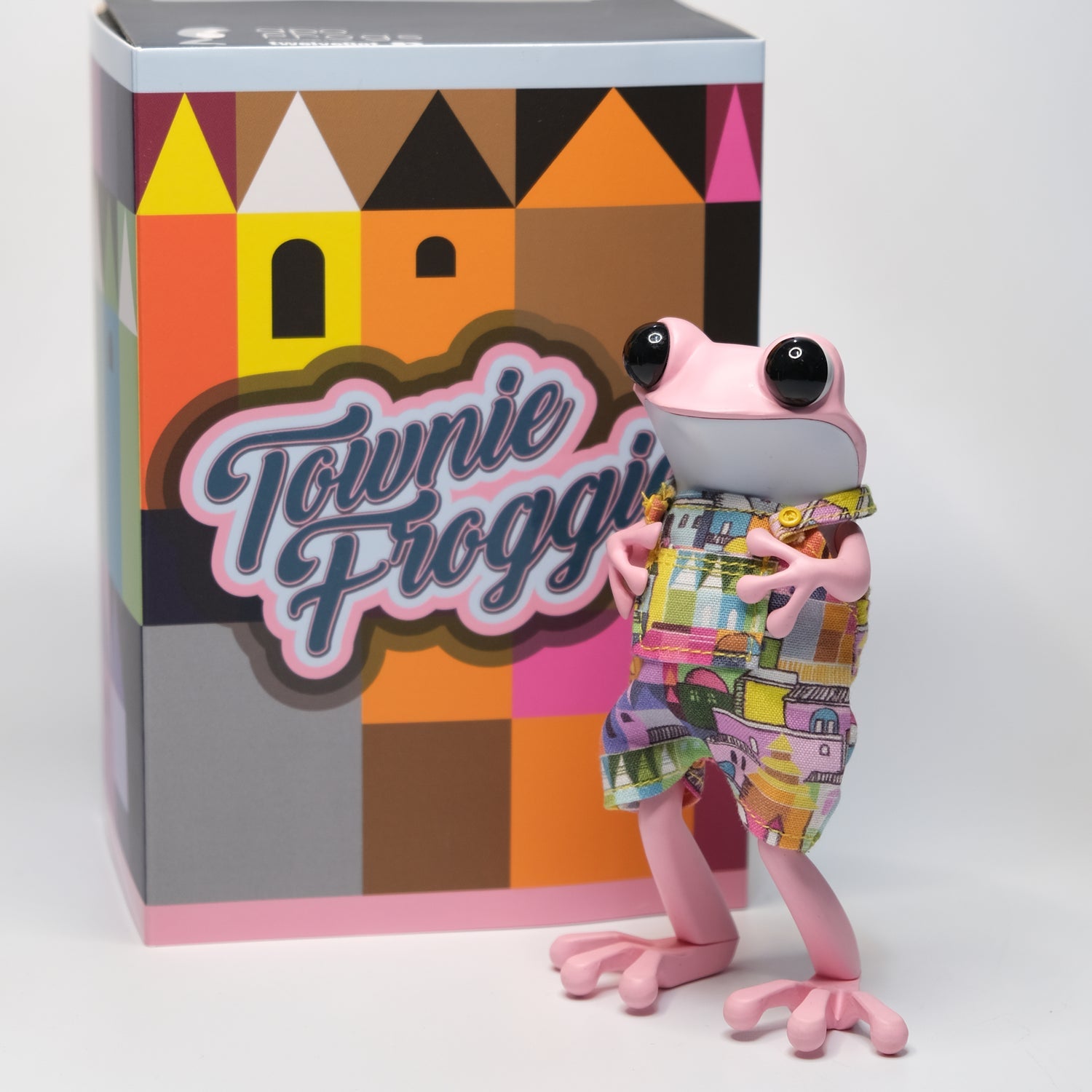 Townie Froggie APO Frog by TwelveDot, a toy frog in overalls next to a box.